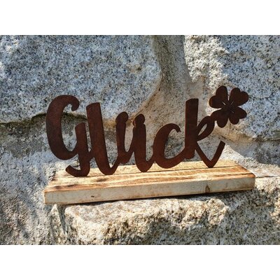 Schriftzug "Glück" auf Holzsockel